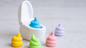 a small toilet with colorful poops sitting on top of it