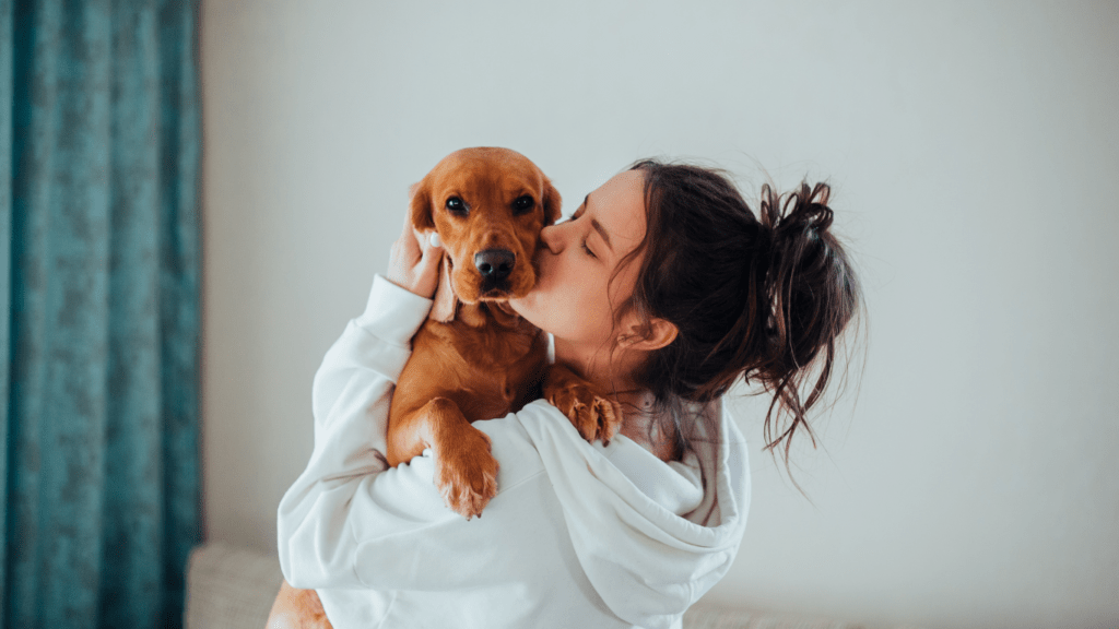 woman kissing her dog