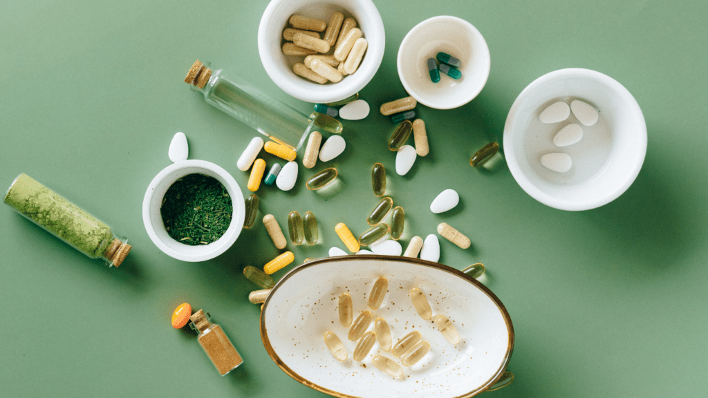 an assortment of pills and pills on a green surface