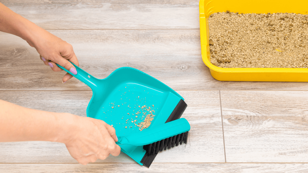 a person is sweeping the floor with a broom and a yellow bucket