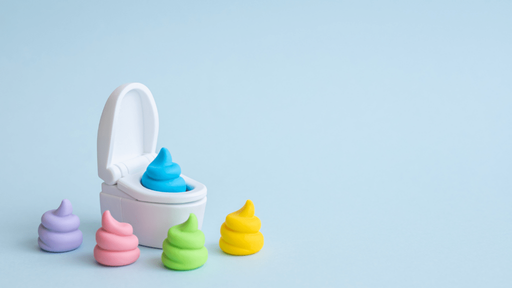 a small toilet with colorful poops sitting on top of it