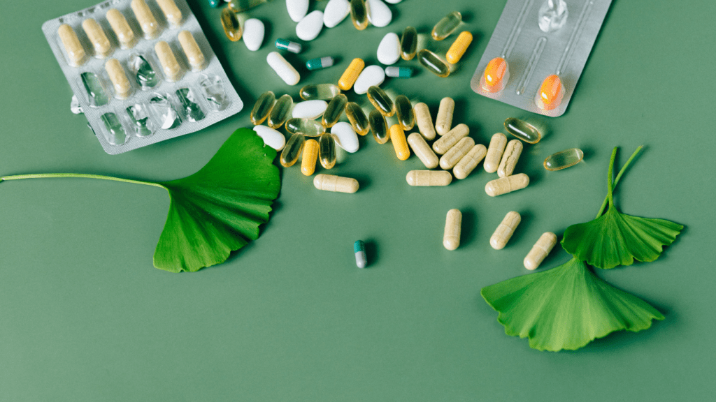 an assortment of pills and pills on a green surface